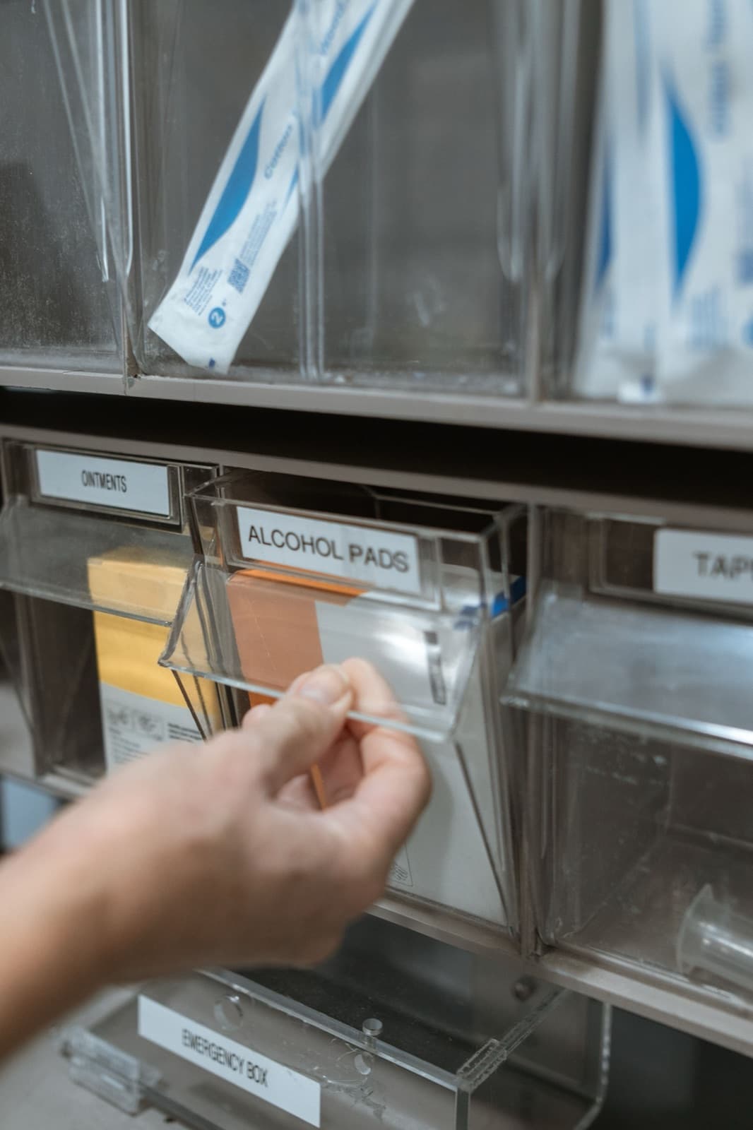 Close-up of medicine bottles organised in rows on a pharmacy shelf